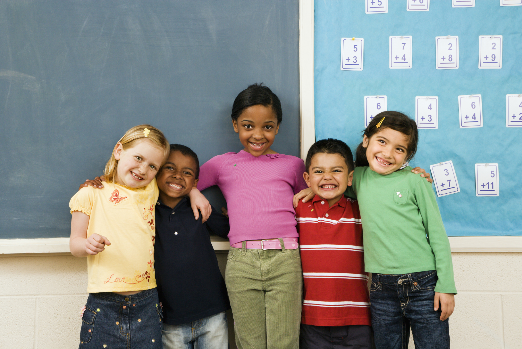 Kids in front of chalkboard in classroom